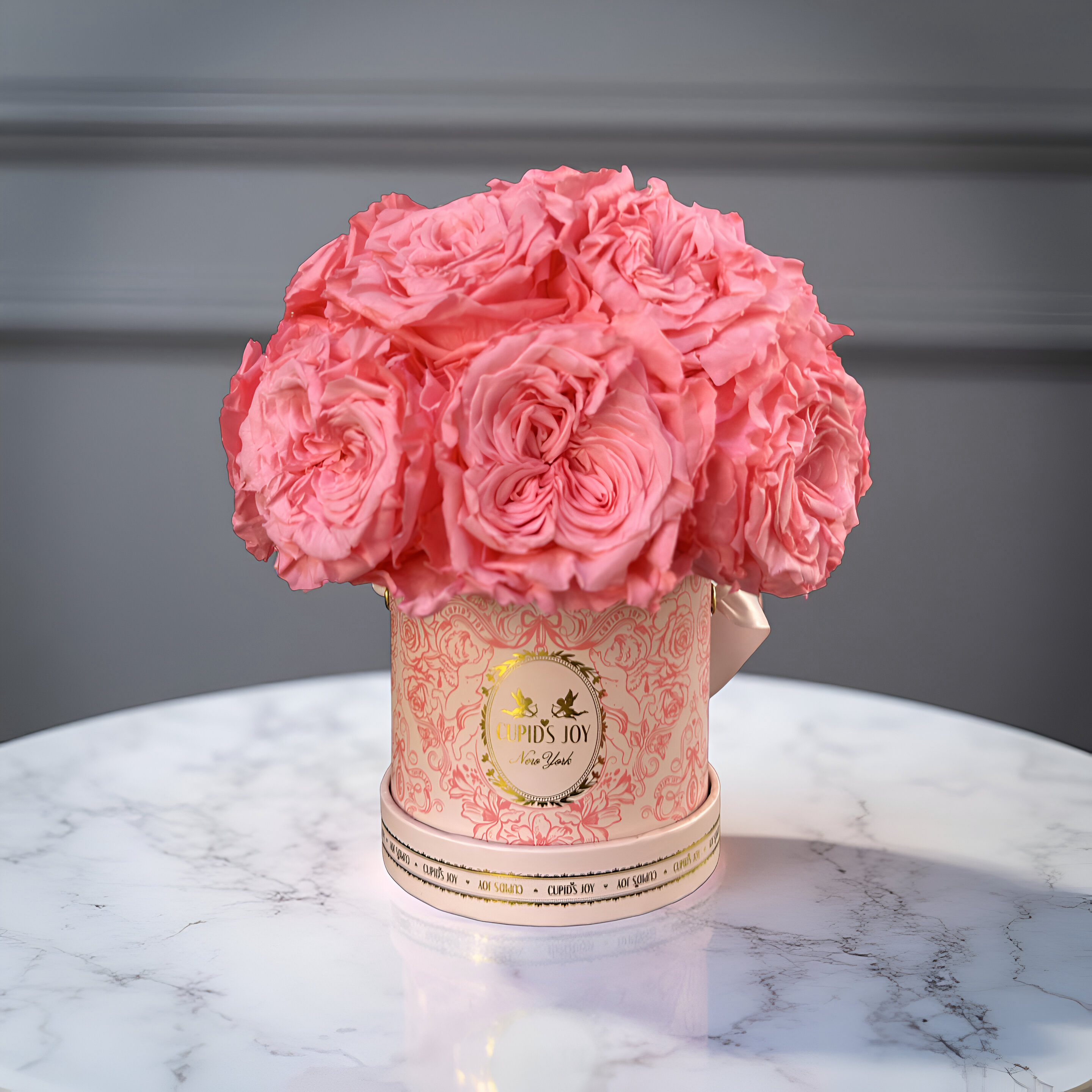 Blush Pink roses in a rose box on a marble surface with a gray background
